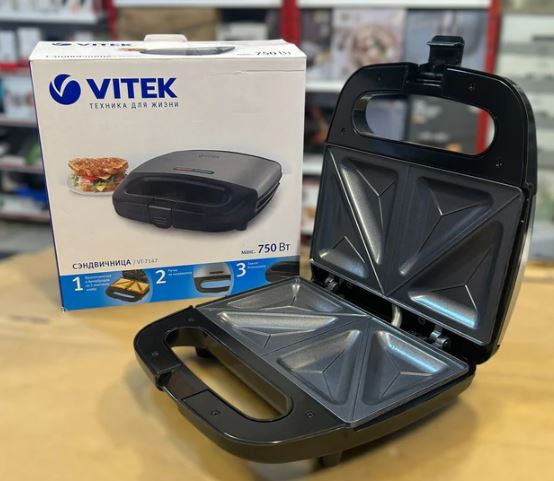 Vitek VT-7147 Sandwich Maker 750W – 4 Slice with non-stick triangular plates open beside its packaging box on table